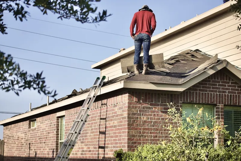 Professional roofer working on a residential roof in Doddtown